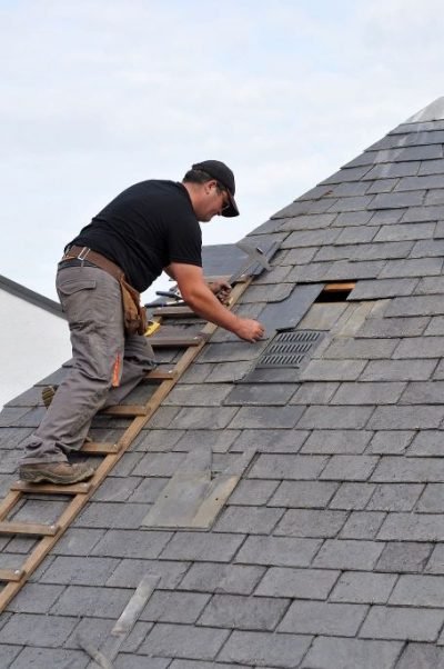 Slate roofing Calgary - roofer trying to fix a slate roof
